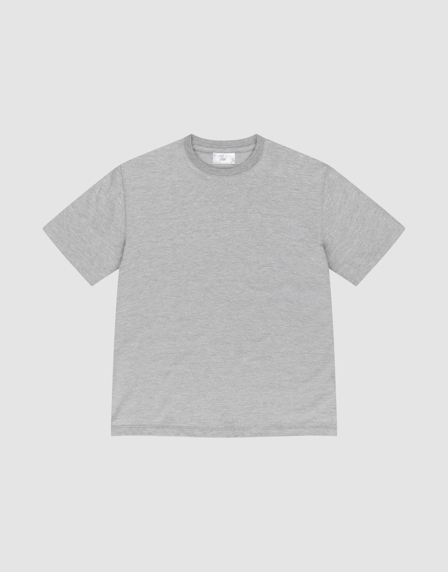 The LIVE FAST DIE YOUNG LFDY Slim Tee is a plain, short-sleeved, light gray slim fit T-shirt made from soft cotton, laid flat on a white background showing its front and subtle flag-label detail.