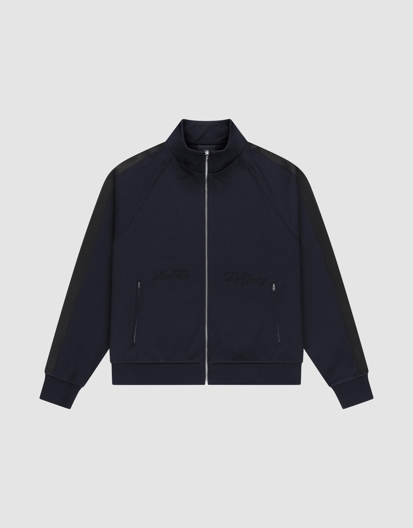 The LFDY Striped Track Jacket by LIVE FAST DIE YOUNG features a navy zip-up design with raglan sleeves, black side stripes, two front zip pockets, and subtle chest embroidery, laid flat on a light gray background.