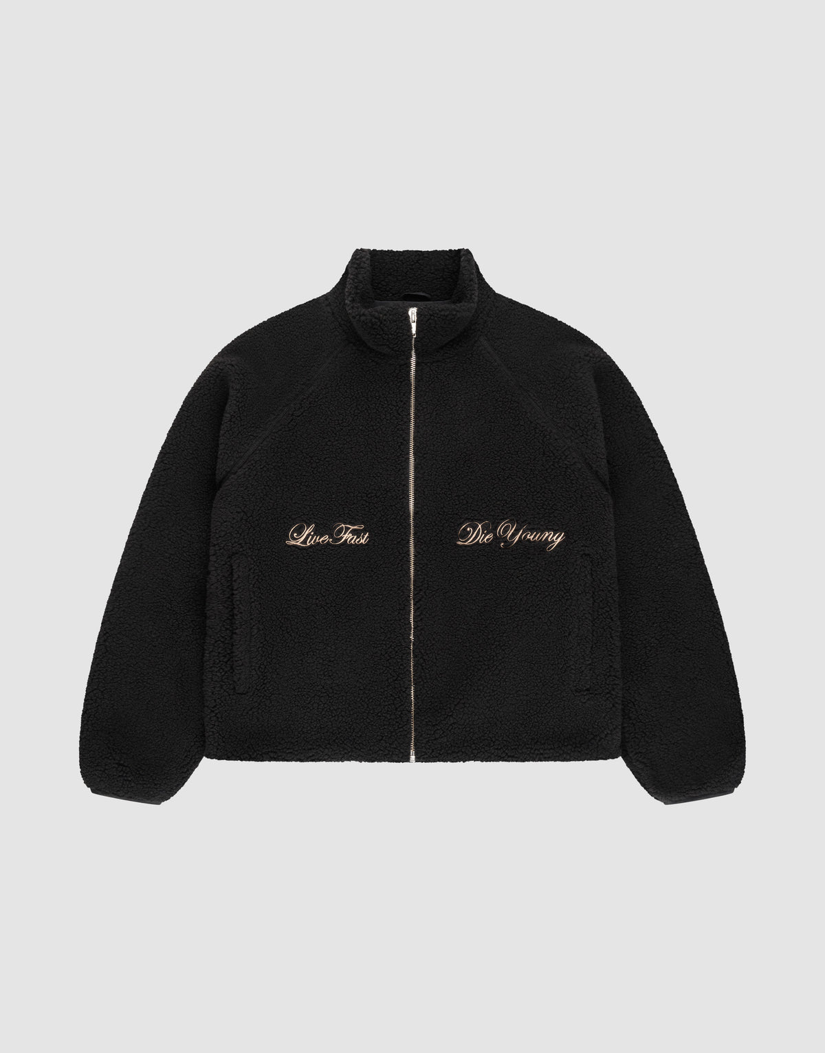 The LFDY Teddy Jacket by LIVE FAST DIE YOUNG is a black fleece jacket with raglan sleeves, side pockets, and gold "Live Fast" and "Die Young" embroidery on the chest, shown on a plain light gray background. | plain
