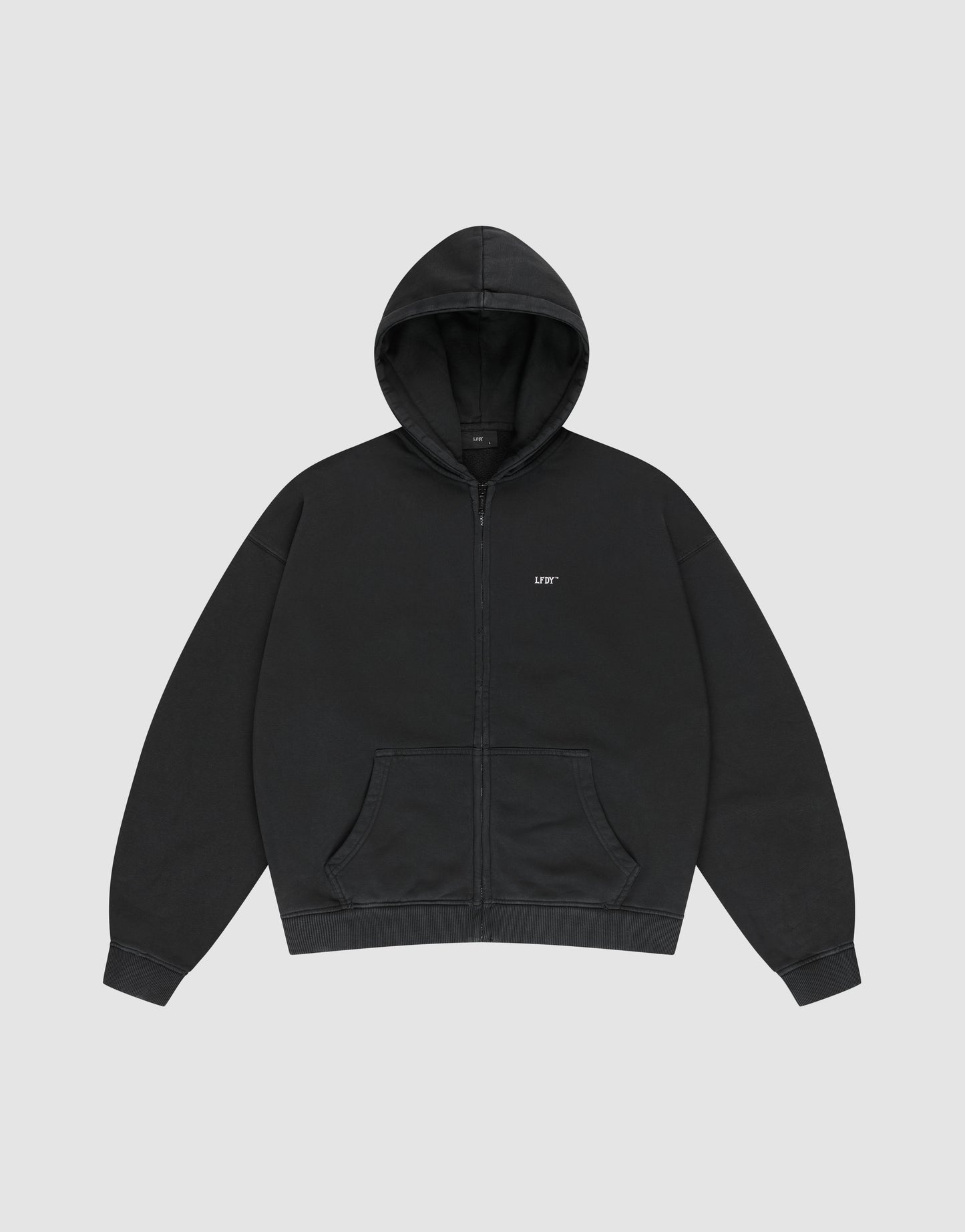 A black Basic Hooded Zip by LIVE FAST DIE YOUNG, oversize fit with front pocket and hood, features a small white LIFE logo on the left chest, shown against a light gray background.