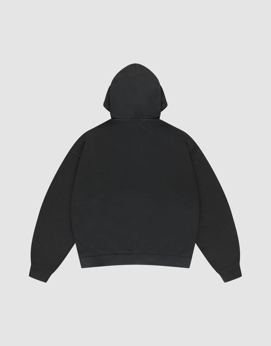 The LIVE FAST DIE YOUNG Basic Hooded Zip is a plain black oversized hoodie shown from the back, featuring a hood, long sleeves, and subtle branding, displayed against a light gray background.
