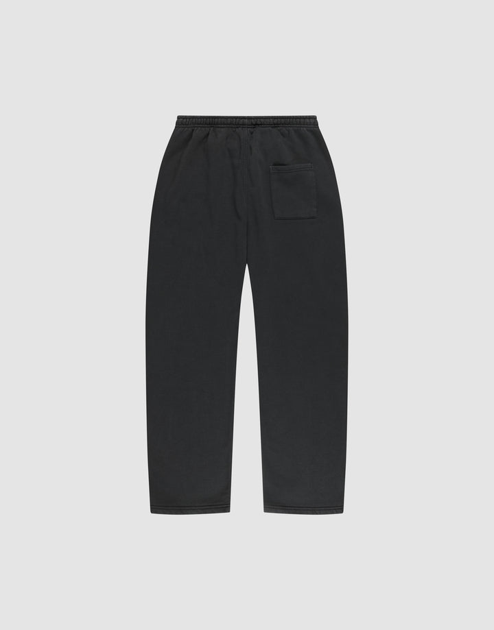 The LIVE FAST DIE YOUNG Basic Wide Jogger features a black wide fit, straight-leg design with an elastic waistband and a single patch pocket on the right, shown flat on a plain light gray background.