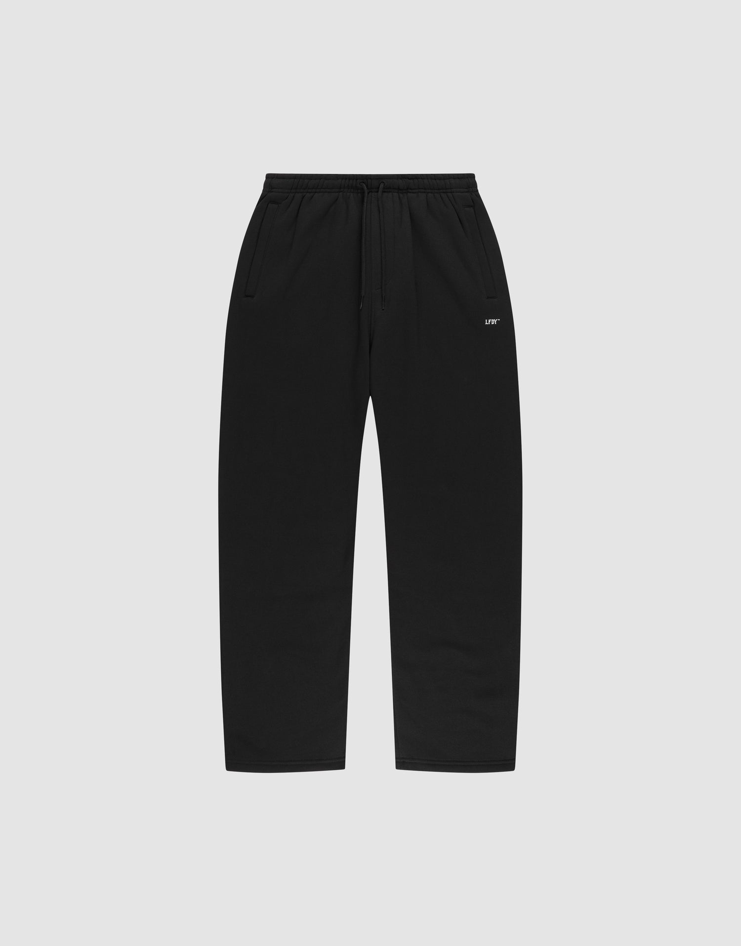 The LIVE FAST DIE YOUNG Basic Wide Jogger features black straight-leg sweatpants with an elastic waistband, drawstring, side pockets, and a small white logo print near the left pocket, shown on a plain light gray background. | plain