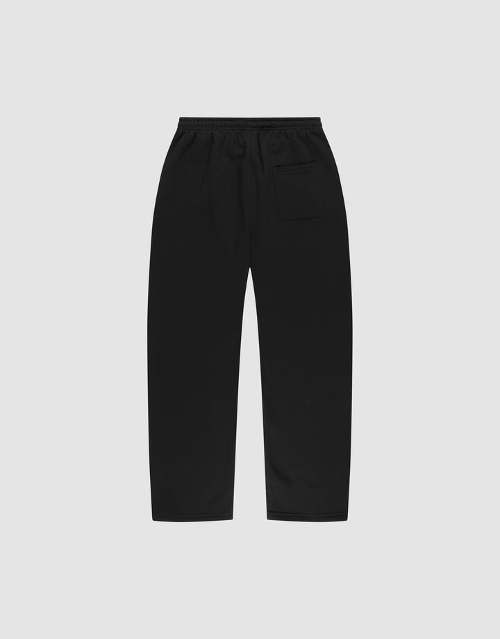 The LIVE FAST DIE YOUNG Basic Wide Jogger in black, designed with an oversized fit, elastic waistband, and single back pocket, is laid flat on a plain light grey background.