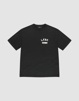 The LFDY District Tee by LIVE FAST DIE YOUNG is a black regular fit short-sleeve t-shirt made from 100% cotton. It features bold white L.F.D.Y. GYM text in a distressed font on the left chest and is shown laid flat on a light gray background. | plain