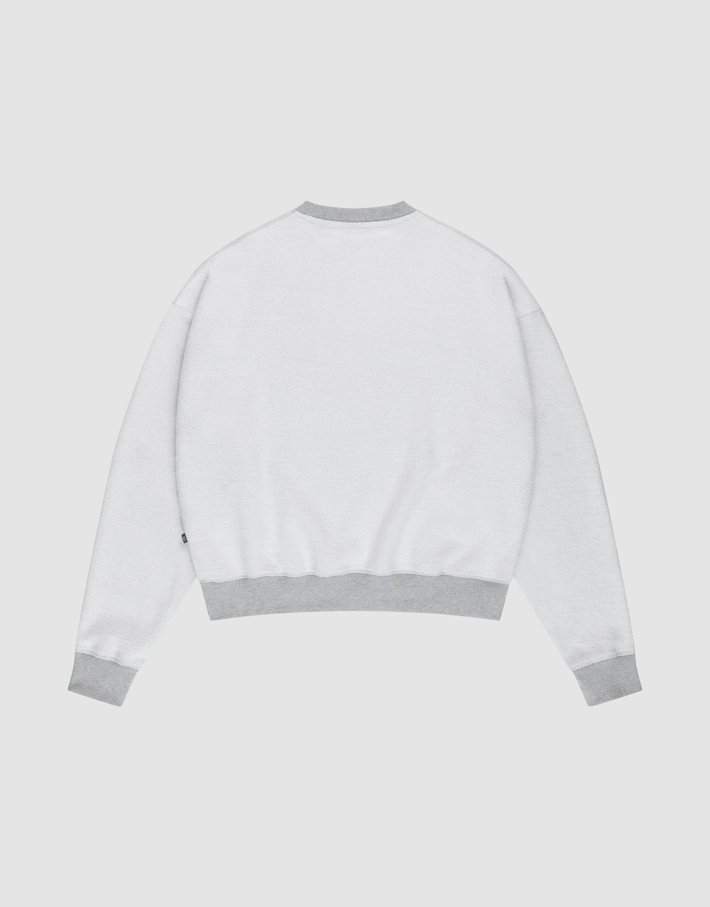 The LFDY District Sweater by LIVE FAST DIE YOUNG is shown from the back in an oversize fit, with light gray ribbed cuffs, waistband, and collar, displayed against a plain white background.