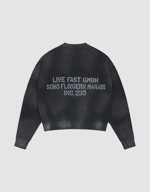 The LFDY Washed Knit Sweater by LIVE FAST DIE YOUNG is black, ribbed, and oversized, with a gray backprint. Made from 100% Baumwolle, it’s shown laid flat on a light gray background. | plain
