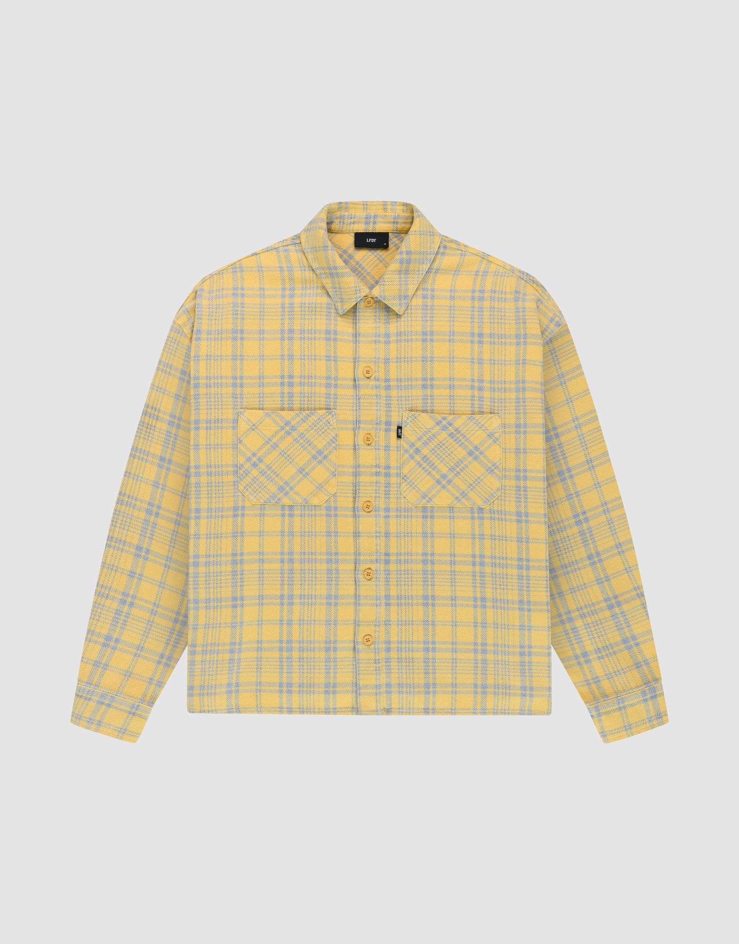 The LIVE FAST DIE YOUNG Vintage Flannel is a yellow and gray plaid oversize long-sleeve button-up shirt with two chest pockets featuring diagonal plaid, a collar, and is shown on a plain white background.