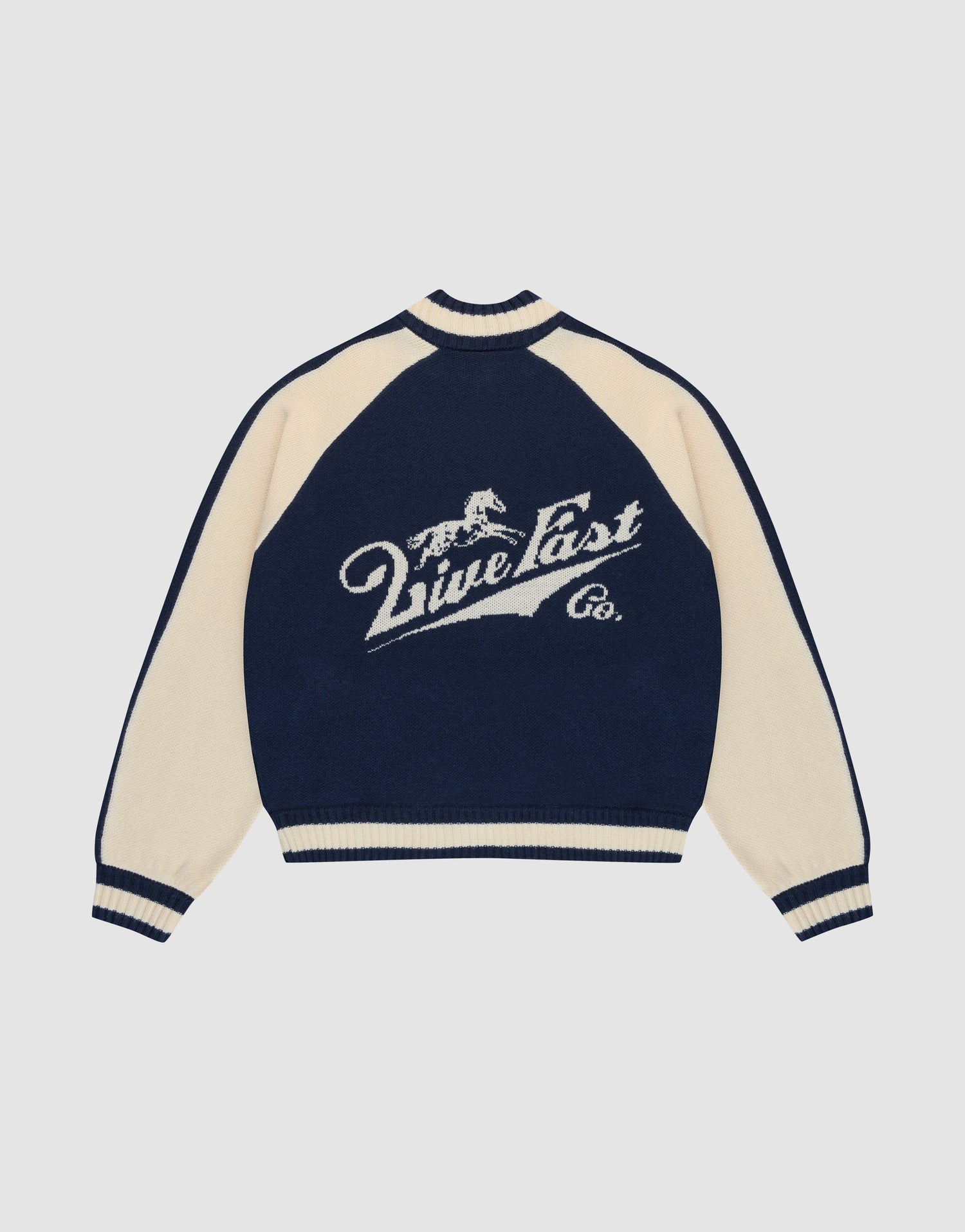 A navy blue and cream Boxy Knit Zip Jacket by LIVE FAST DIE YOUNG, with oversized fit, long raglan sleeves, and a large intarsia-knit running horse graphic above "Live Fast Co." script on the back. | plain