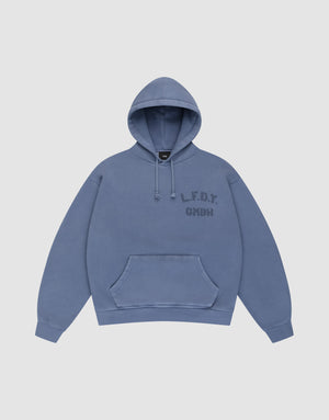 A blue LFDY GmbH Hooded hoodie by LIVE FAST DIE YOUNG with an oversize fit, drawstring hood, front pocket, and “L.F.D.Y. GMBH” in dark blue on the left chest. Displayed flat on a plain light background for a clean look. | plain