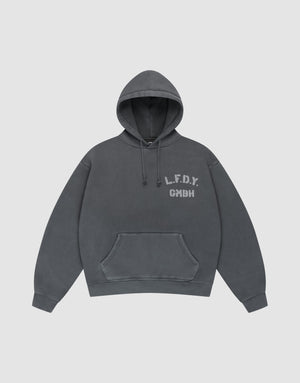 The LIVE FAST DIE YOUNG LFDY GmbH Hooded is a dark gray oversize-fit hoodie with drawstring hood and front pocket, featuring white "L.F.D.Y. GMBH" print on the left chest and subtle vintage wash, shown flat on a light gray background. | plain
