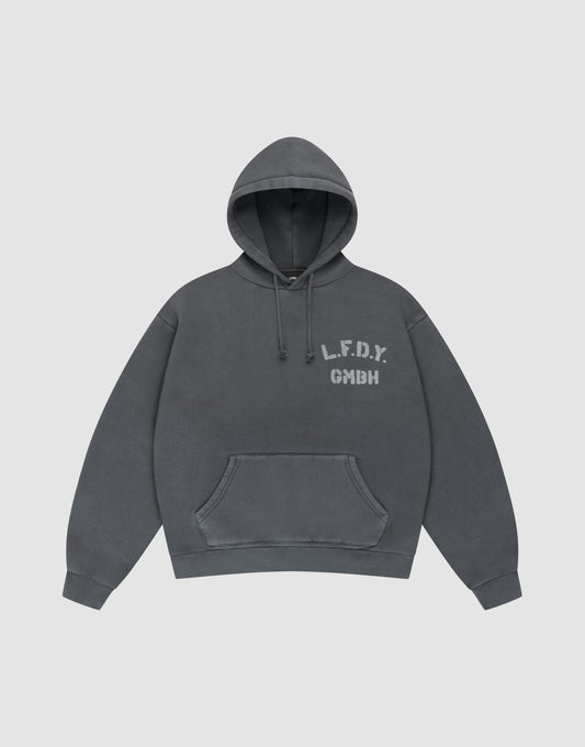 The LIVE FAST DIE YOUNG LFDY GmbH Hooded is a dark gray oversize-fit hoodie with drawstring hood and front pocket, featuring white "L.F.D.Y. GMBH" print on the left chest and subtle vintage wash, shown flat on a light gray background. | plain