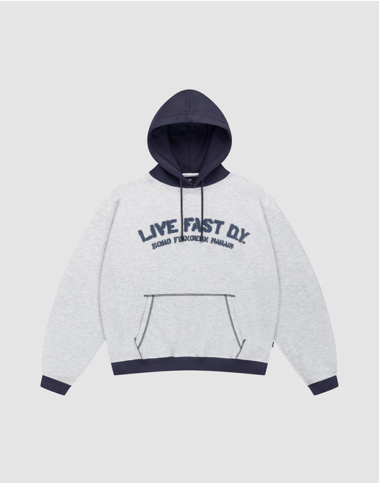 The LFDY District Hooded by LIVE FAST DIE YOUNG features a light gray oversize fit, dark blue contrast hood, cuffs, and hem. Front print: "LIVE FAST D.I.Y." with "BOARD FINGERS PALMS" below. Includes a kangaroo pocket. | plain