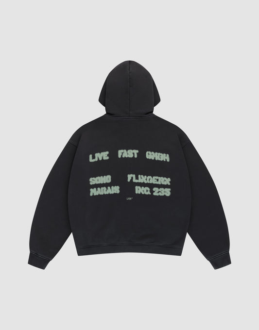 The Live Fast District Hooded Zip by LIVE FAST DIE YOUNG features an oversized black fit with light green spray-painted style text—LIVE FAST 6HIGH, SONG MARJAN, FLUXGEIST, INC. 235—and subtle LFDY branding on the back, shown flat on a plain light background. | plain