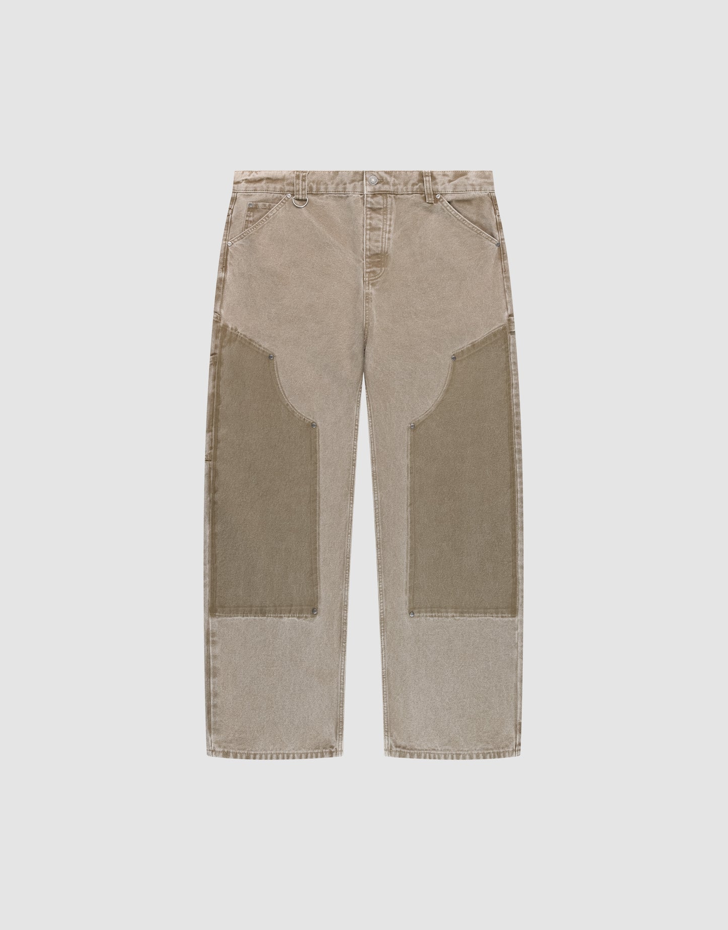 The LIVE FAST DIE YOUNG Faded Carpenter Pants are beige, straight-leg, baggy-fit jeans with large darker beige patches on the front thigh and knee, featuring front pockets and belt loops, displayed flat on a light background.