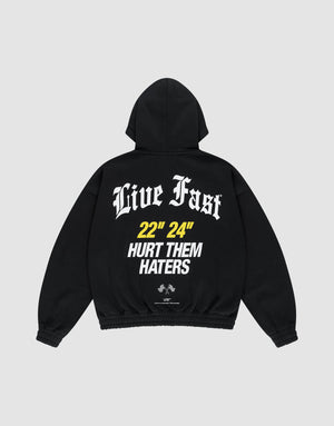 The LFDY Haters Hooded Zip by LIVE FAST DIE YOUNG is a black oversized hoodie with “Live Fast” in bold white gothic text, “22 24” in yellow on the back, small graphics near the hem, a double-layer hood, and front/back prints. | plain