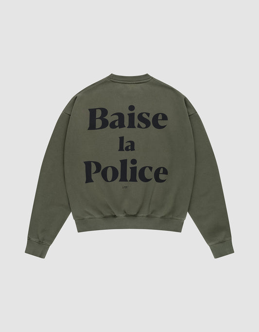 The LFDY BLP Sweater by LIVE FAST DIE YOUNG is an olive green oversized crewneck in a cotton-poly blend, featuring bold black "Baise la Police" French logo print across the back.