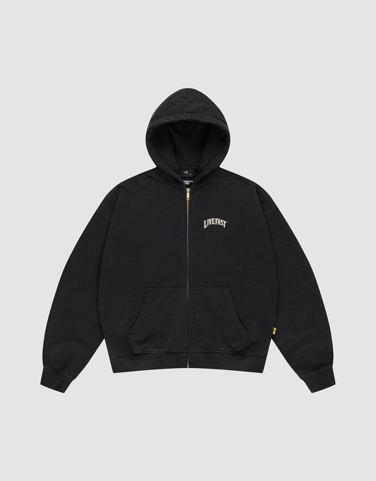 The LFDY x The Bulldog Hooded Zip by LIVE FAST DIE YOUNG is an oversized black zip-up hoodie with front pockets, a hood, and "LIVE FAST" in a white logo print on the left chest. It is shown flat on a plain light gray background.