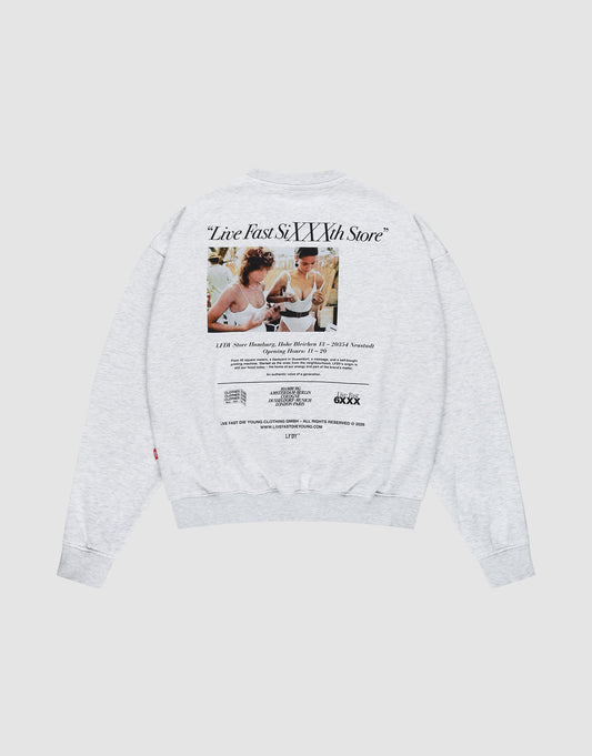 The LIVE FAST DIE YOUNG LFDY SiXXXth Store Sweater is a light gray oversized cotton sweatshirt with a large back graphic of two people eating ice cream at a table and “Live Fast, SIXTYNTH Store” text above and below.| plain 