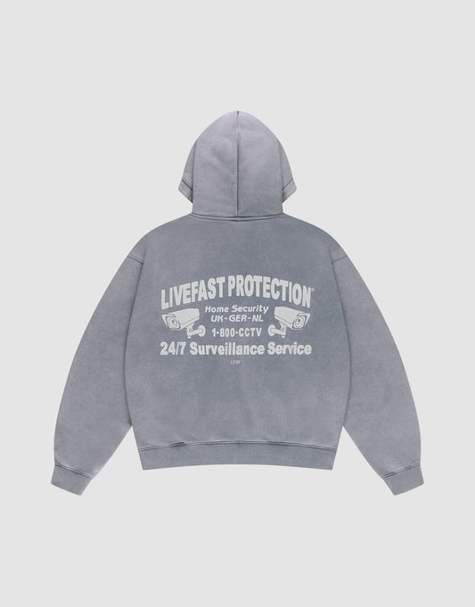 The LFDY Protection Hooded Zip by LIVE FAST DIE YOUNG is a gray hoodie with Kapuze and features white "LIVEFAST PROTECTION, Home Security, 1-800-CCTV, 24/7 Surveillance Service" text plus two security camera illustrations on the back. | plain