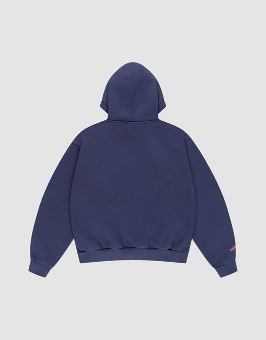 The Live Fast Stallion Hooded by LIVE FAST DIE YOUNG is shown flat in navy blue cotton, back view on a white background. It features an oversized fit, ribbed cuffs and hem, and a small pink detail on the left sleeve.