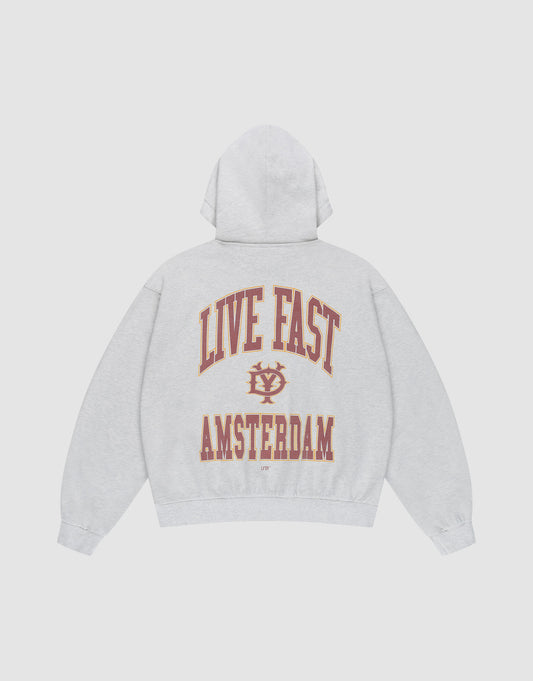 The Live Fast Amsterdam Hooded by LIVE FAST DIE YOUNG is a light gray oversized sweatshirt in 100% cotton, featuring bold red and gold "LIVE FAST" lettering and emblem on the back, plus AMSTERDAM. Front and back prints make it stand out. | plain