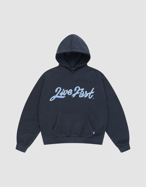 The LFDY Script Hooded by LIVE FAST DIE YOUNG features a dark navy oversize fit, front pouch pocket, bold light blue "Live Fast" script on the chest, and distressed effects, shown against a plain light gray backdrop. | plain
