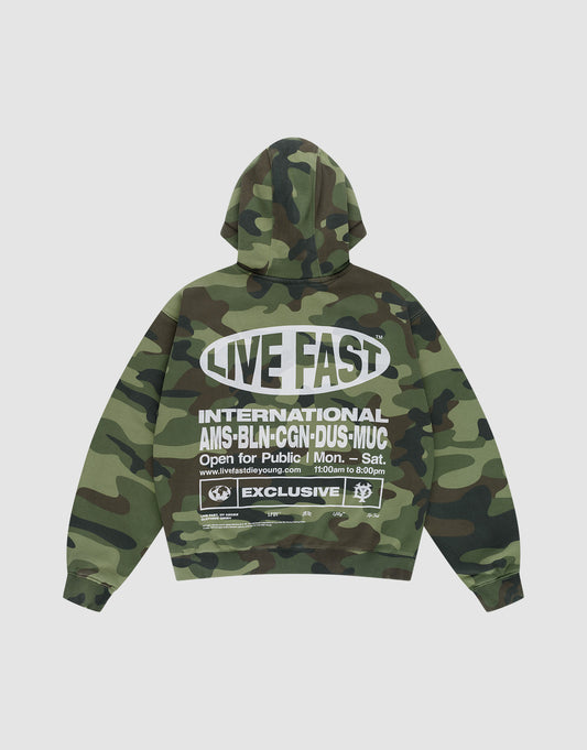 The LFDY Army Hooded Zip by LIVE FAST DIE YOUNG features a green camo design, bold white “LIVE FAST” text on the back, vintage-effect details, city info, logos, labels, opening hours, and cozy waffle lining for comfort. | plain