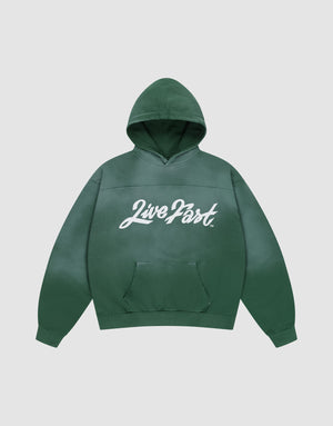 The LFDY Script Hooded by LIVE FAST DIE YOUNG is a green oversized hoodie with a front pocket and "Live Fast" in bold white script on the chest, featuring subtle distress effects. Shown against a plain light gray background. | plain