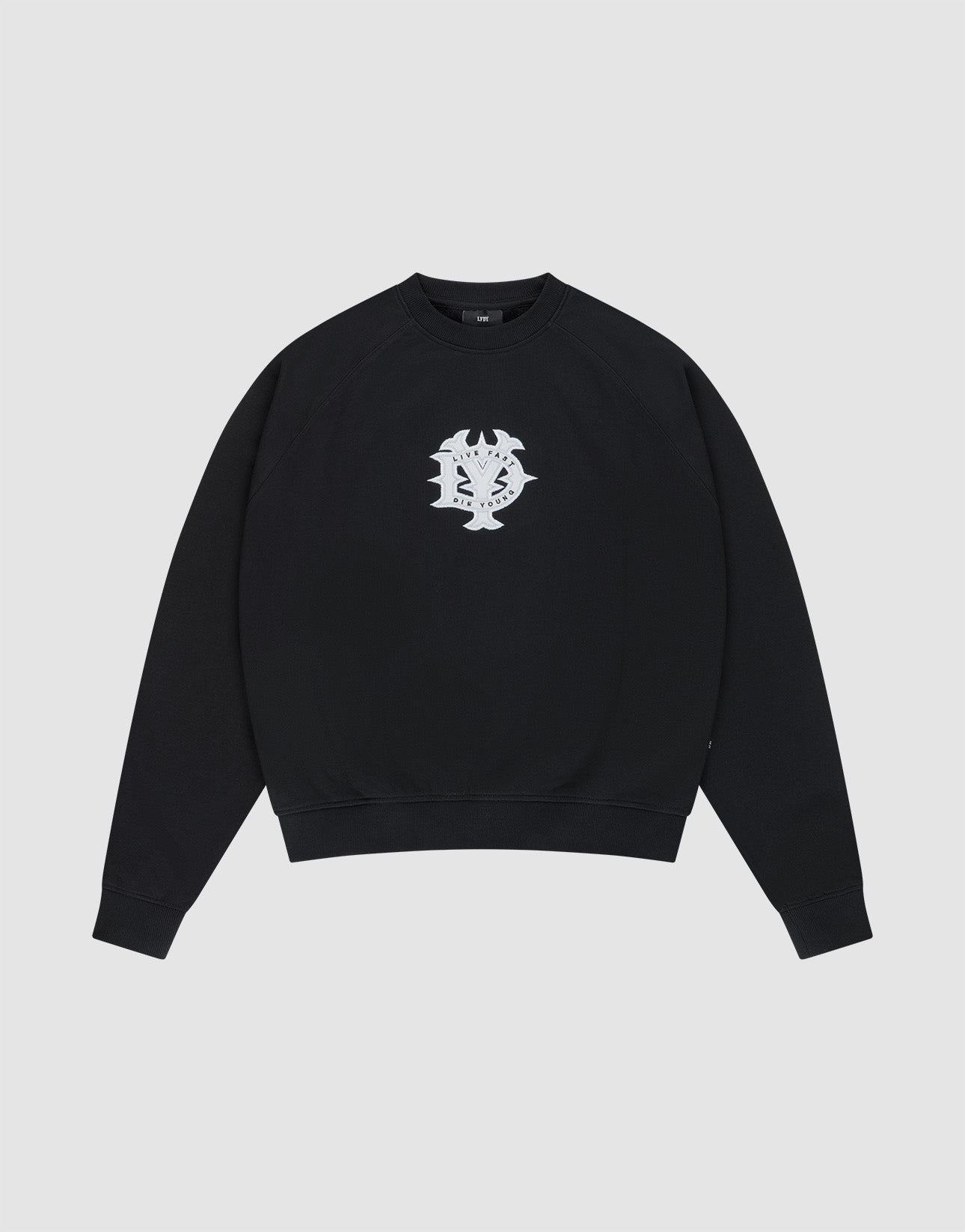 The DY Sweater by LIVE FAST DIE YOUNG is a black crewneck with raglan sleeves and a white abstract chest graphic, made from 100% cotton. Shown on a plain light gray background. | plain