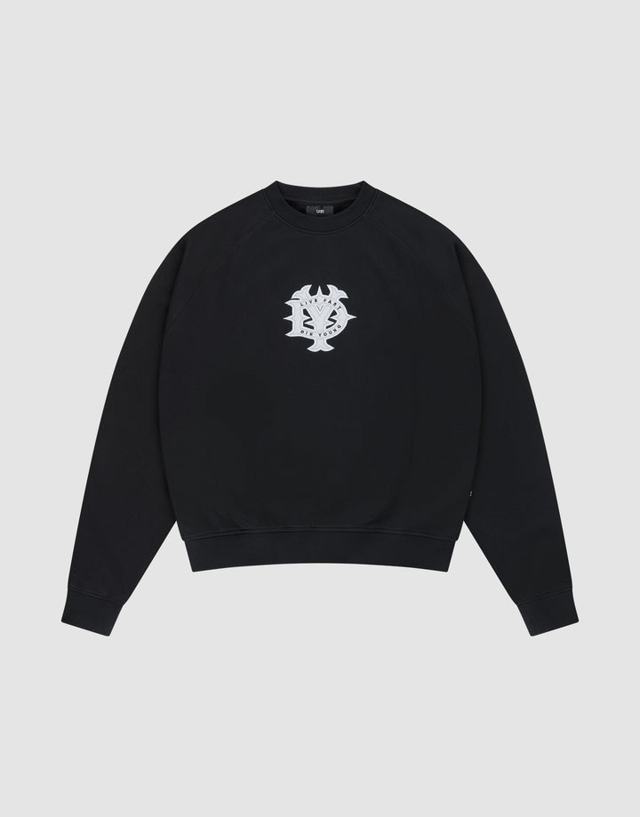 The DY Sweater by LIVE FAST DIE YOUNG is a black crewneck with raglan sleeves and a white abstract chest graphic, made from 100% cotton. Shown on a plain light gray background. | plain