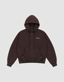 The LFDY Pleated Hooded Zip by LIVE FAST DIE YOUNG is a dark brown oversized zip-up hoodie with a drawstring hood, front pockets, and small white LIFE FAST text on the chest. Made from 100% Baumwolle. Shown on a plain light gray background. | plain