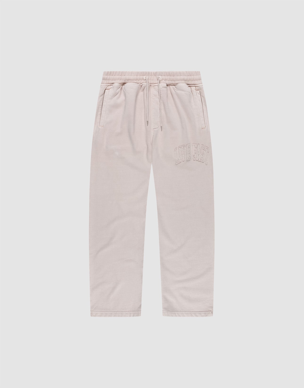 The Ripped College Wide Jogger by LIVE FAST DIE YOUNG features a wide fit, elastic waistband with drawstring, side pockets, and CUTE AF embroidery on soft Baumwolle, shown in light beige against a plain white background.