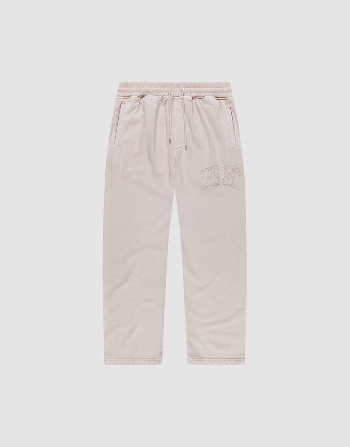 The Ripped College Wide Jogger by LIVE FAST DIE YOUNG features a wide fit, elastic waistband with drawstring, side pockets, and CUTE AF embroidery on soft Baumwolle, shown in light beige against a plain white background. | plain