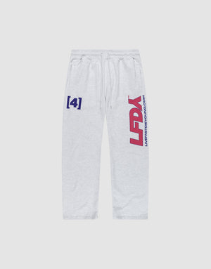 The LFDY Racing Wide Jogger by LIVE FAST DIE YOUNG is made from soft cotton in light gray with a wide fit and broad elastic waistband. Blue “[4]”, red “LFDY”, and blue “LIFTEDSTRONG.COM” graphics accent both thighs. | plain