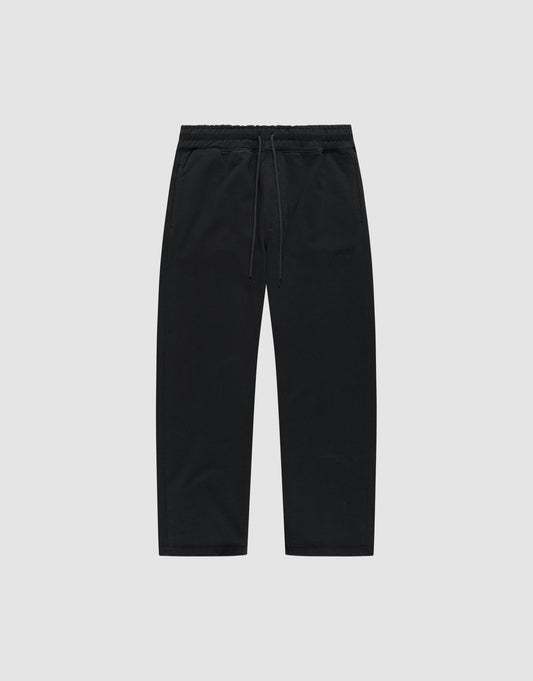The LIVE FAST DIE YOUNG Basic Wide Jogger is a pair of black, wide-fit cotton pants with an elastic waistband and drawstring, shown flat on a light grey background. | plain