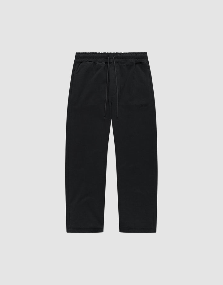The LIVE FAST DIE YOUNG Basic Wide Jogger is a pair of black, wide-fit cotton pants with an elastic waistband and drawstring, shown flat on a light grey background. | plain