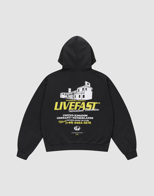 The LFDY Supply Hooded by LIVE FAST DIE YOUNG is an oversized black hoodie in a Baumwolle-Polyester blend, featuring a front discharge print and a bold white building graphic with "LIVE FAST" text and phone number details on the back. | plain