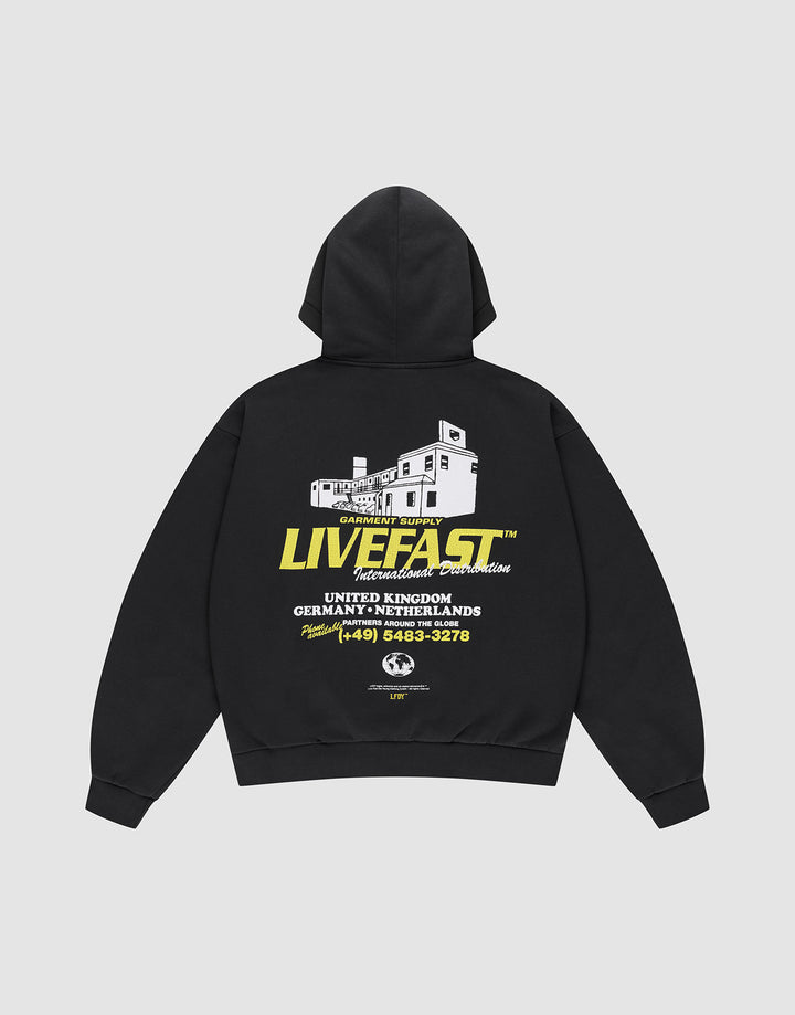 The LFDY Supply Hooded by LIVE FAST DIE YOUNG is an oversized black hoodie in a Baumwolle-Polyester blend, featuring a front discharge print and a bold white building graphic with "LIVE FAST" text and phone number details on the back. | plain