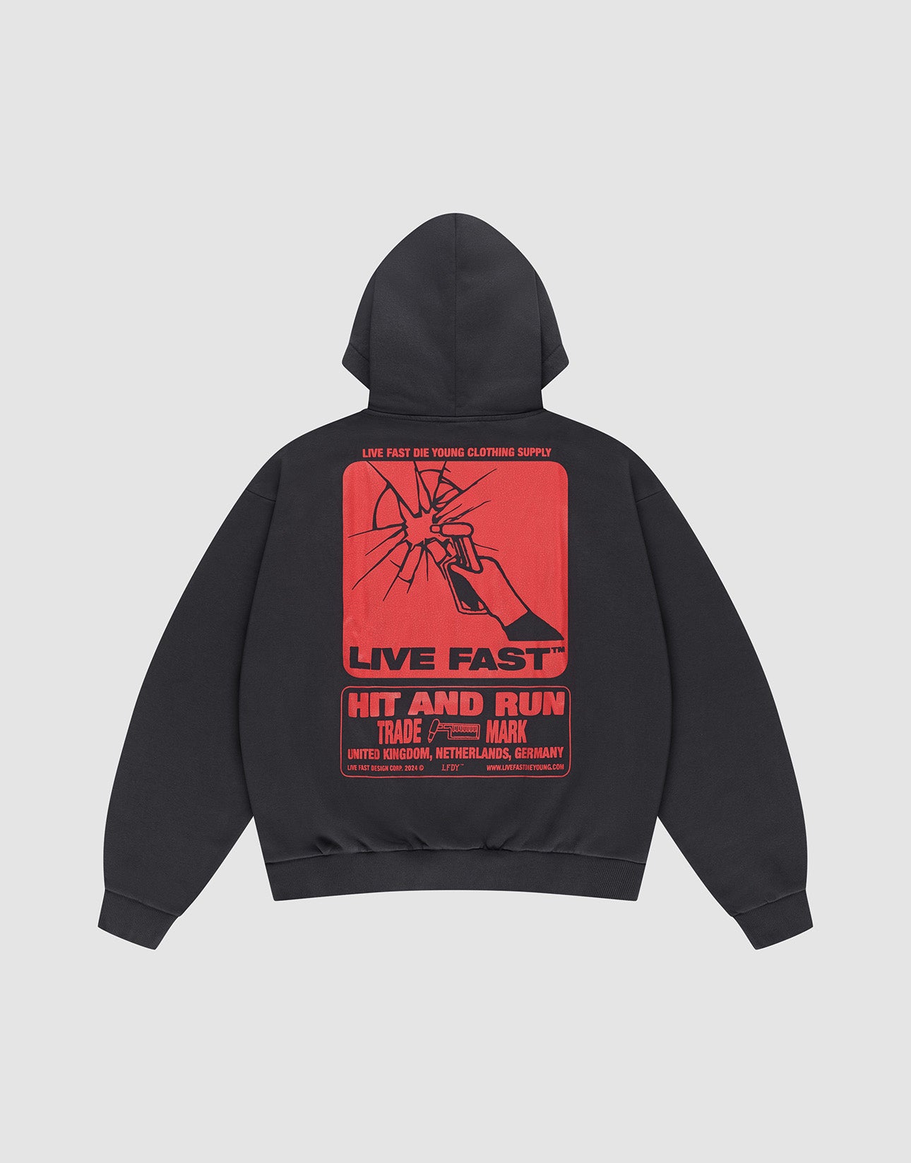 The Hit and Run Hooded by LIVE FAST DIE YOUNG is an oversized black sweatshirt with a large cracked glass backprint, bold red “LIVE FAST” and “HIT AND RUN” text, plus country names: United Kingdom, Netherlands, Germany.