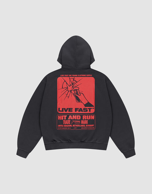 The Hit and Run Hooded by LIVE FAST DIE YOUNG is an oversized black sweatshirt with a large cracked glass backprint, bold red “LIVE FAST” and “HIT AND RUN” text, plus country names: United Kingdom, Netherlands, Germany.