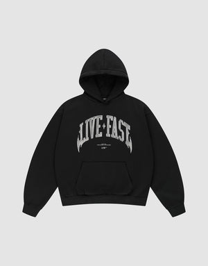 The Live Fast Axe Hooded by LIVE FAST DIE YOUNG is an oversized black hoodie with a front pocket and bold silver "LIVE FAST" front print, made from soft cotton and shown laid flat on a light gray background. | plain