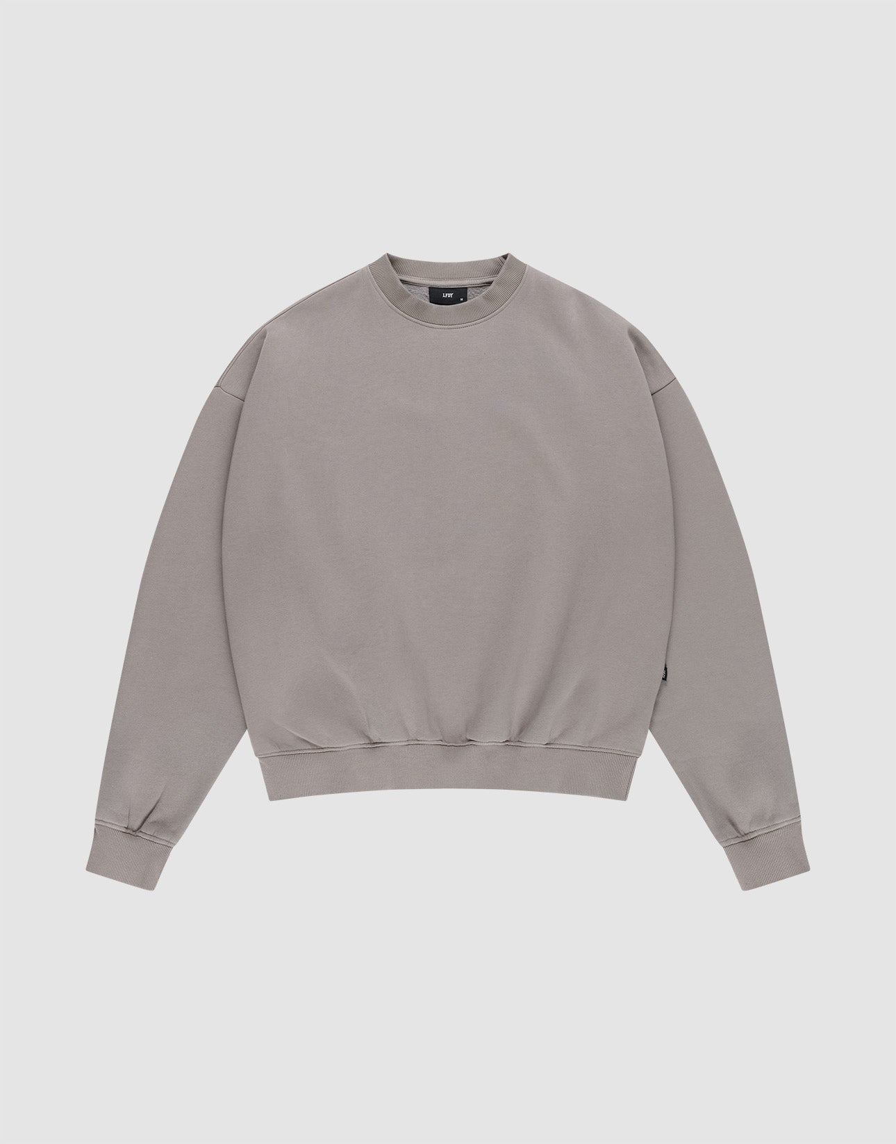 The LIVE FAST DIE YOUNG Basic Blank Sweater, a light grey vintage-washed crewneck with long sleeves, is laid flat on a white background for a classic, timeless look. | plain