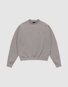 The LIVE FAST DIE YOUNG Basic Blank Sweater, a light grey vintage-washed crewneck with long sleeves, is laid flat on a white background for a classic, timeless look. | plain