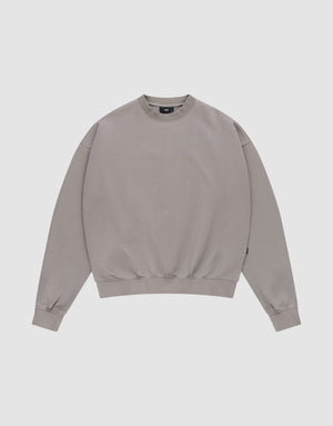 The LIVE FAST DIE YOUNG Basic Blank Sweater, a light grey vintage-washed crewneck with long sleeves, is laid flat on a white background for a classic, timeless look. | plain