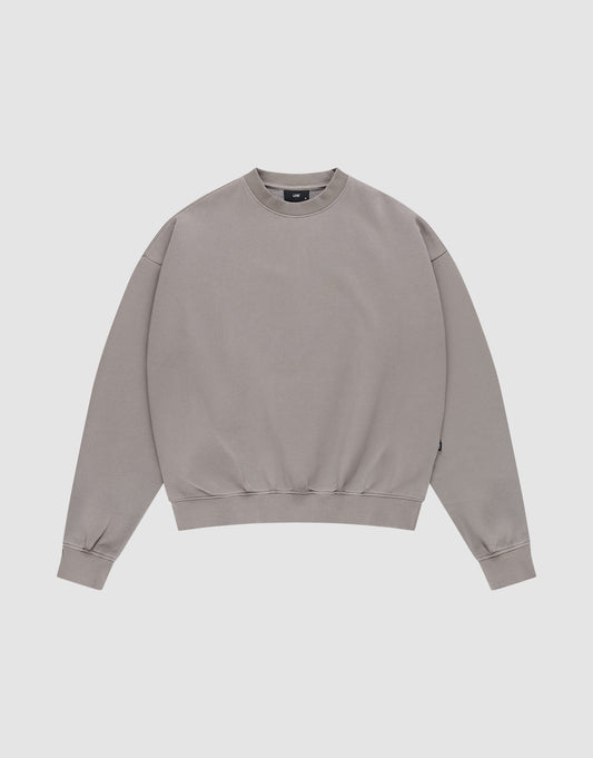 The LIVE FAST DIE YOUNG Basic Blank Sweater, a light grey vintage-washed crewneck with long sleeves, is laid flat on a white background for a classic, timeless look. | plain