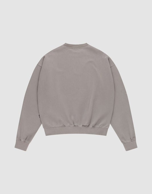 The LIVE FAST DIE YOUNG Basic Blank Sweater is a light gray, oversized, long-sleeve sweatshirt with ribbed cuffs, collar, and waistband, shown laid flat with the back facing up on a white background.