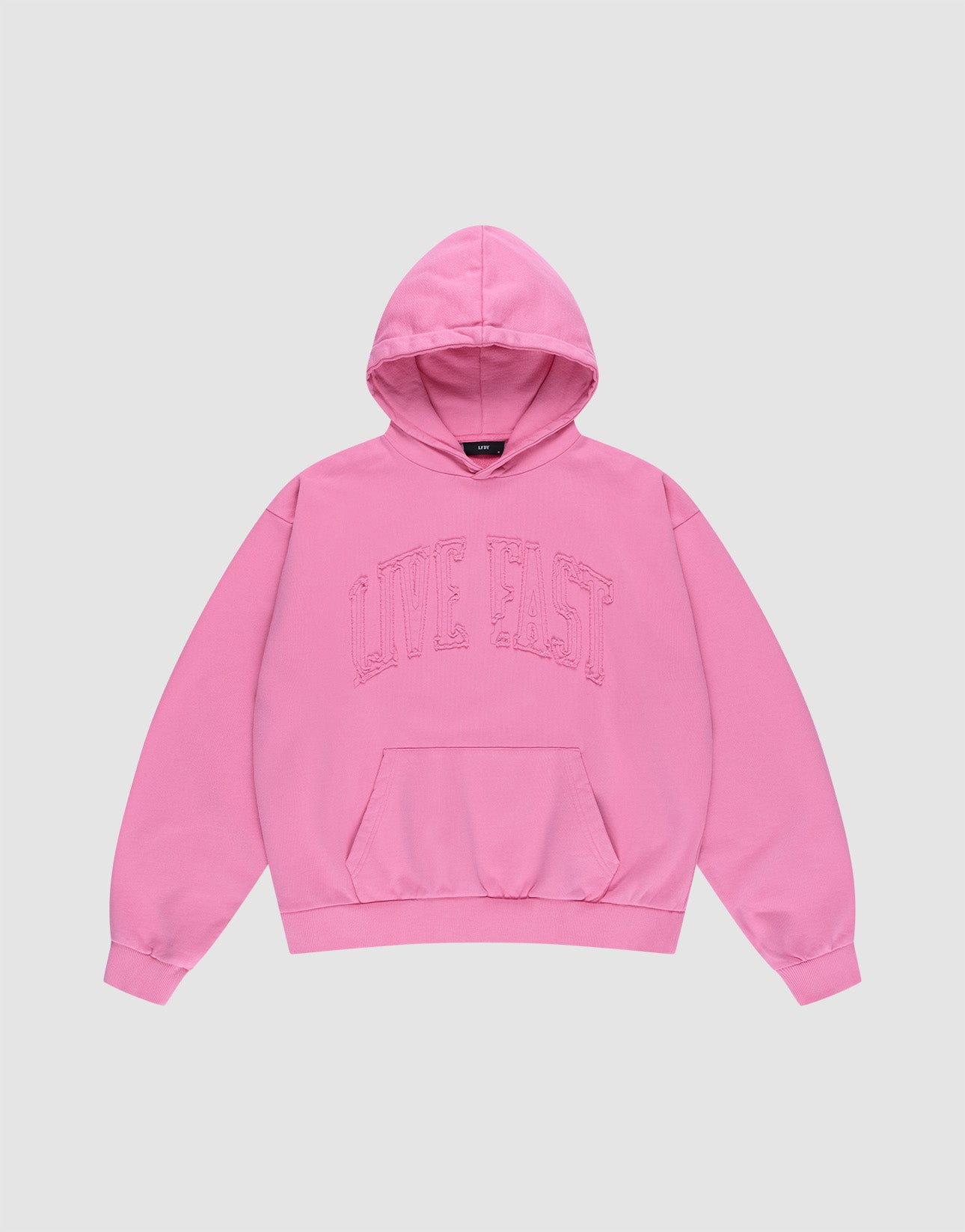 The Ripped College Hooded by LIVE FAST DIE YOUNG is a bright pink oversized hoodie made from 100% Baumwolle, featuring a front pocket and bold "LIVE FAST" lettering across the chest, shown laid flat on a plain light background. | plain
