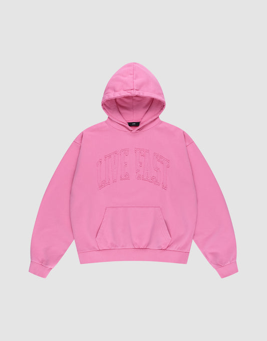 The Ripped College Hooded by LIVE FAST DIE YOUNG is a bright pink oversized hoodie made from 100% Baumwolle, featuring a front pocket and bold "LIVE FAST" lettering across the chest, shown laid flat on a plain light background. | plain