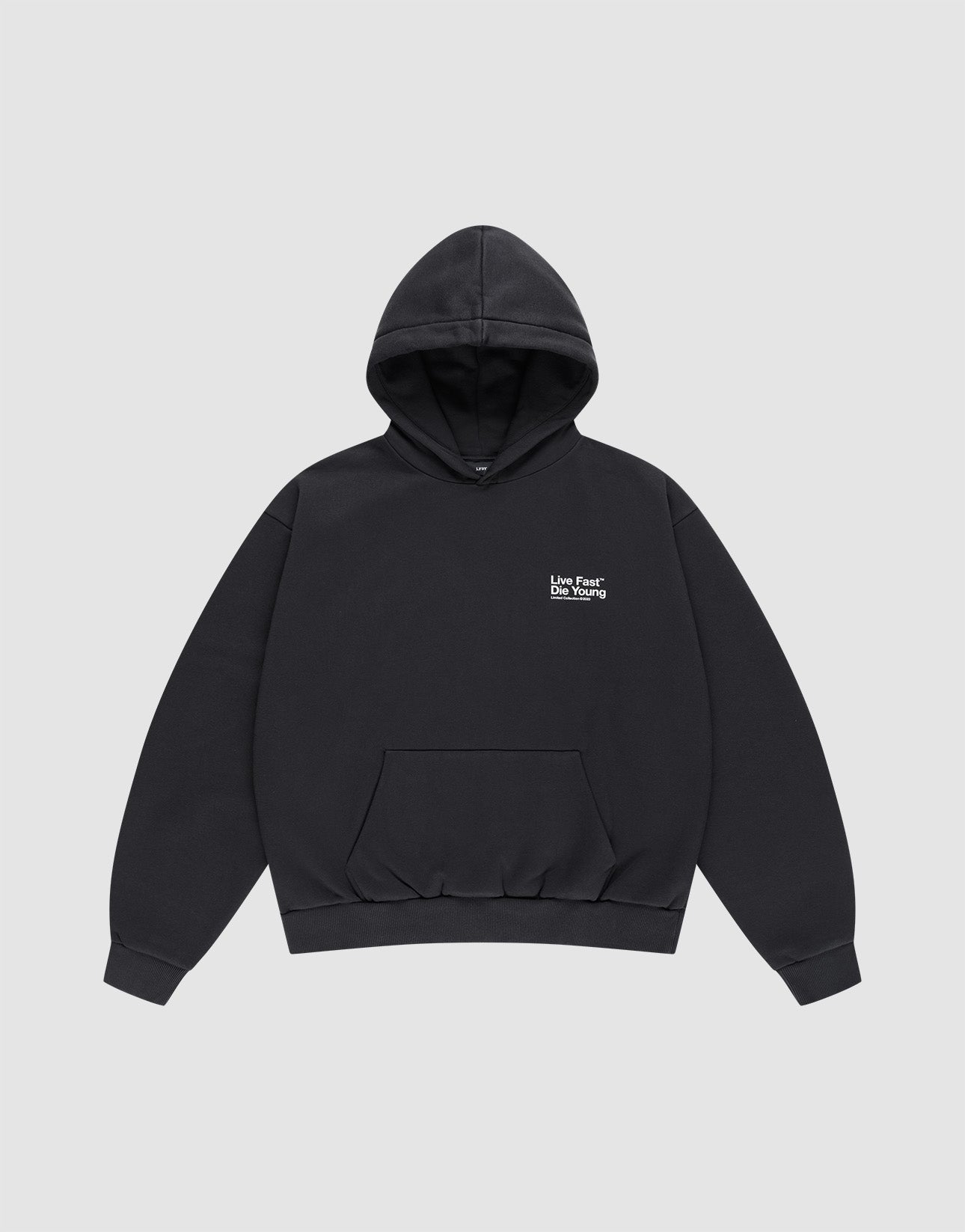 The Live Fast NY Hooded by LIVE FAST DIE YOUNG is a black oversized cotton hoodie with a front pocket and small white "Love Fear Love Yourself" text on the left chest, shown laid flat on a light gray background.